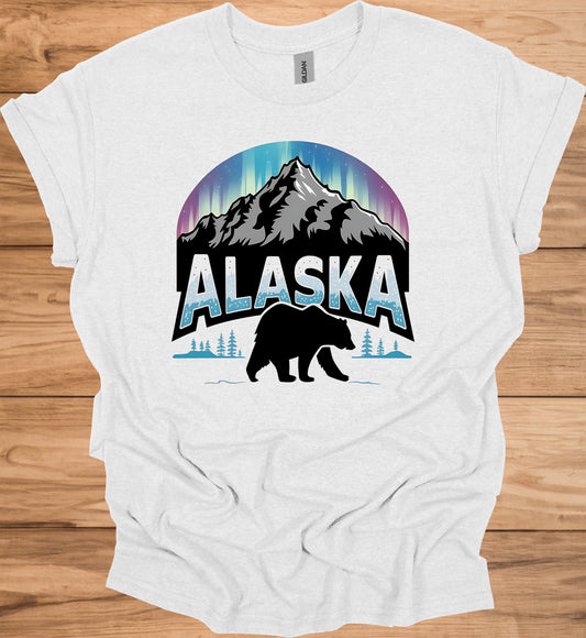 Alaska's Wilderness Wonder: Northern Lights Over Mountains, Bear Silhouette Graphic, Icy Text Design - Graphic Tee Shirt