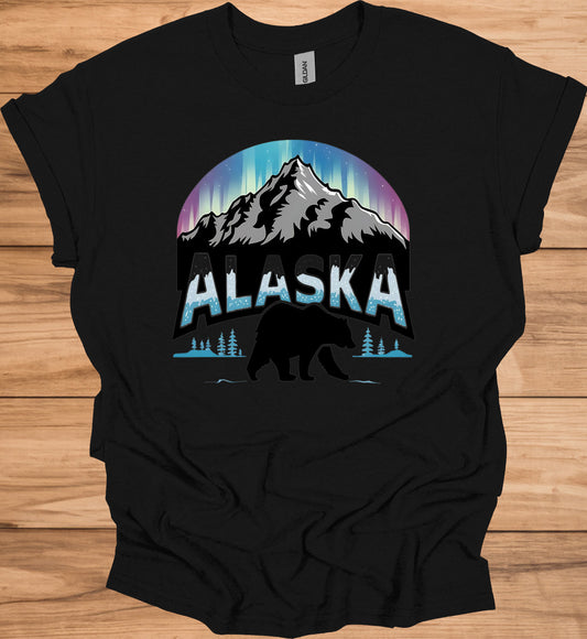 Alaska's Wilderness Wonder: Northern Lights Over Mountains, Bear Silhouette Graphic, Icy Text Design - Graphic Tee Shirt