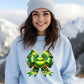 Festive green bow design on light blue sweatshirt product type