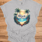 The Beach Is Calling: Beach Sunset Illustration, Heart-Shaped Palm Tree Frame, Wanderlust Inspiration Artwork - Graphic Tee Shirt